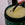 Jar of salt body scrub with a spoon scooping out some of the scrub.